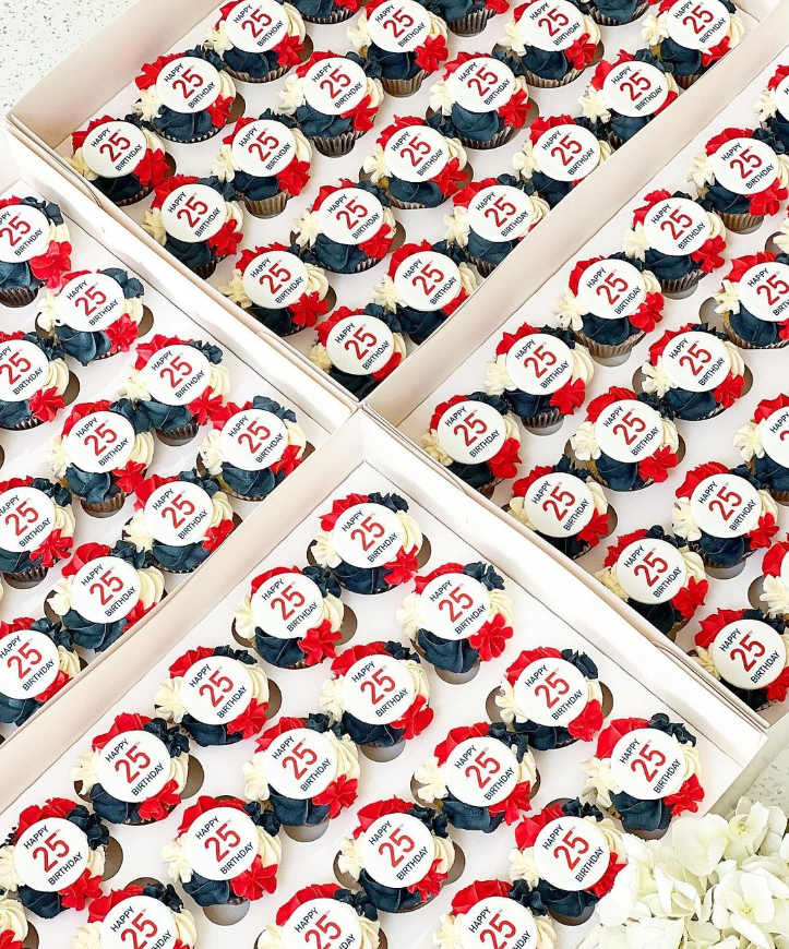 mini cupcakes with red, white and blue piped icing topped with a printed edible topper with a birthday message.