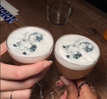 2 two foamed cocktails with edible images floating on the foam. The wafer print shows a lady in black and white