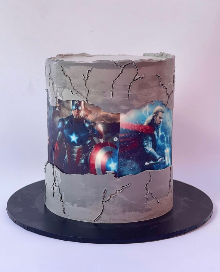 marvel themed cake with a fault line image wrapped around the center featuring thor and captain america.