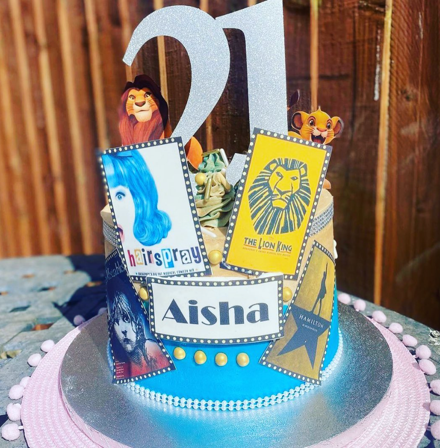 edible images of theatre poster boards cover a one tier birthday cake.