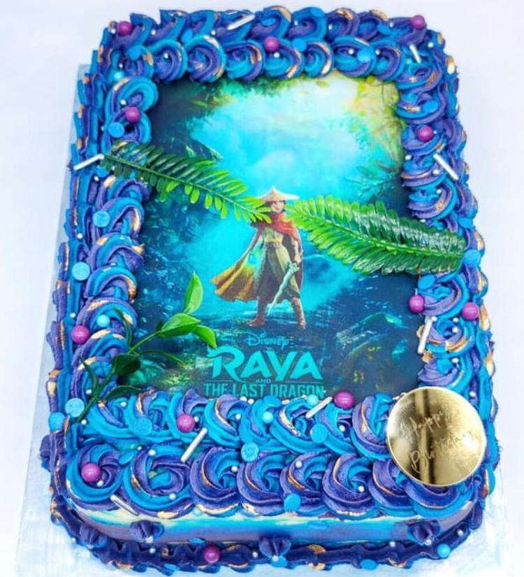 personalised blue cake with an edible icing sheet with an image of Rava. The cake has blue buttercream swirls around the printed icing
