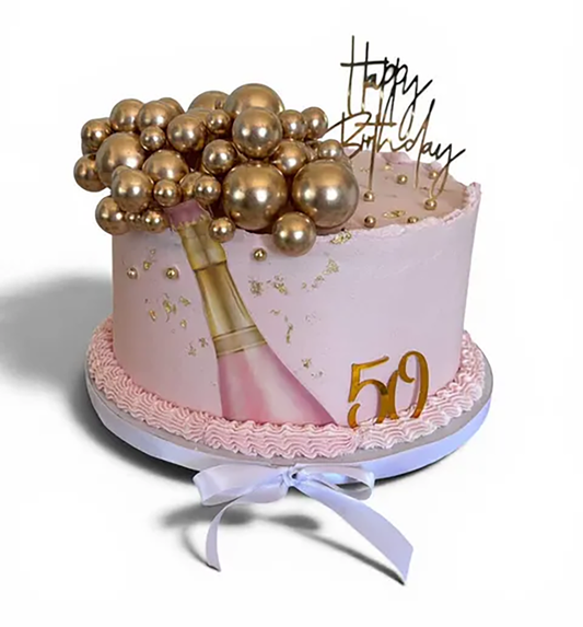 A pink frosted birthday cake decorated with a champagne bottle illustration, gold balloons, gold confetti, a gold '59' numeral, and a gold 'Happy Birthday' script topper, shown on a white background.